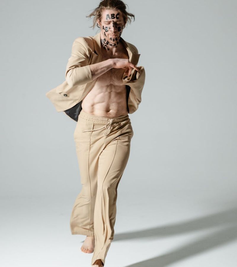 Person in a spacious, minimalist room performing a fluid movement.